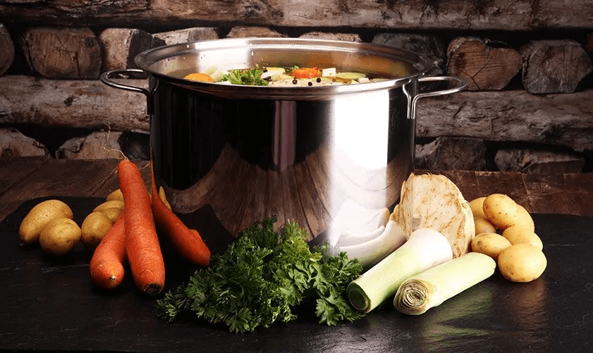 A stainless steel stockpot filled with vegetables