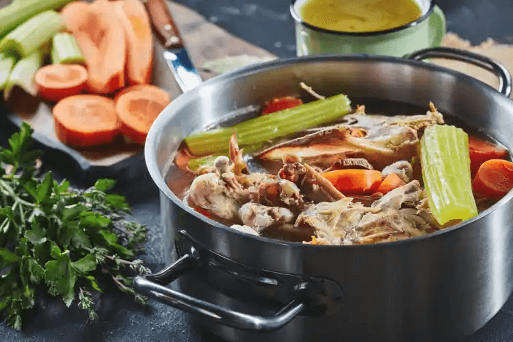 A stockpot cooking vegetable soup
